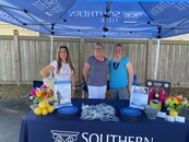 Dawn Aquino, Cheryl Rapoano, and Andrea Hicks sharing Southern Title's support for the family of fallen Ormond Beach Corporal Michael Bakaysa at the DBAAR Fundraiser event.